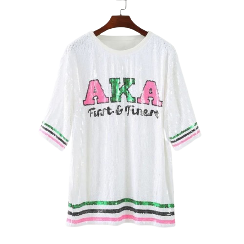 Alpha Kappa Alpha sorority sequence dress in white, featuring a large graphic AKA symbol.