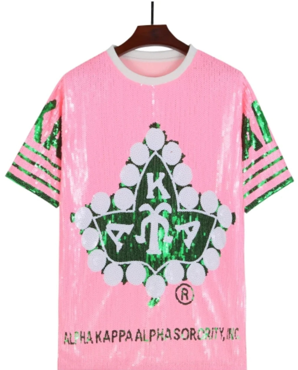 Alpha Kappa Alpha sorority sequence dress in pink, featuring a large graphic symbol.