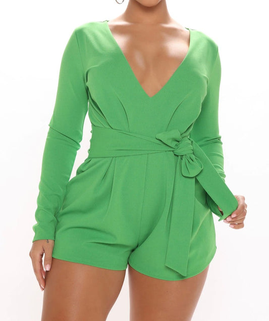 This pretty green short one piece is truly a statement piece! With its deep V-neck design and long sleeves, it exudes a chic and elegant vibe. The front-tied waist belt adds a touch of sophistication and helps accentuate your waistline. It's definitely a versatile and fashionable addition to any wardrobe.